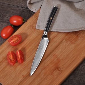 A knife sitting on top of a wooden cutting board