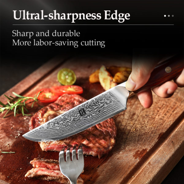A hand holding a knife on a cutting board