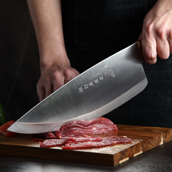 A person with a knife on a cutting board